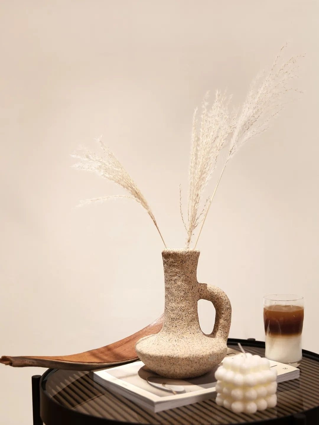 奶油花藝甜品店桌面靜物，石紋陶器花器、白色芒草與冰拿鐵